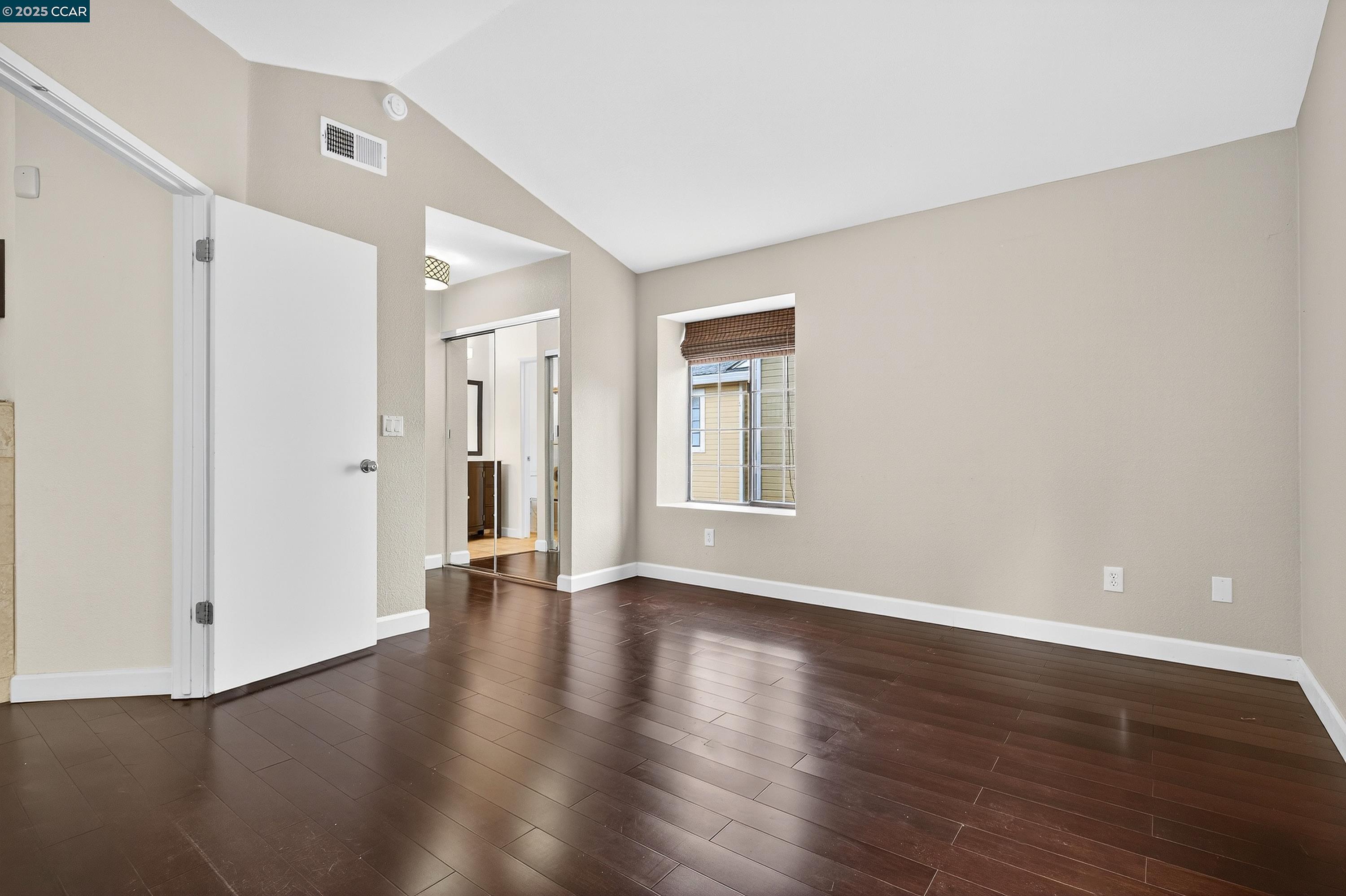 1202 Devonwood Hercules, CA 94547 - Photo 21 of 46 a view of an empty room with wooden floor and a window