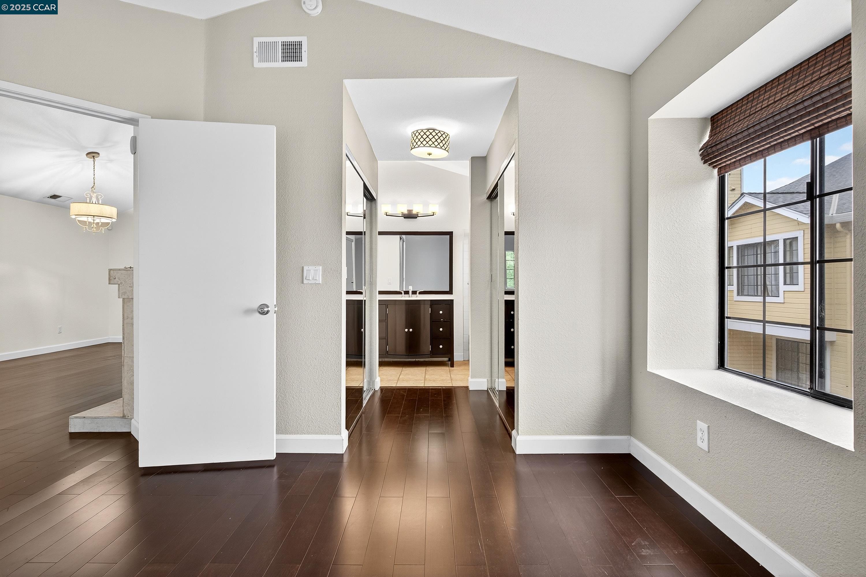 1202 Devonwood Hercules, CA 94547 - Photo 22 of 46 a view of a hallway with wooden floor and a cabinet