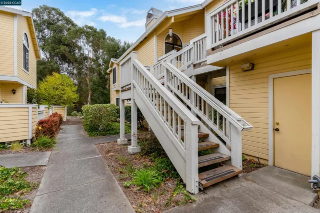 a backyard of a house with wooden floor and fence