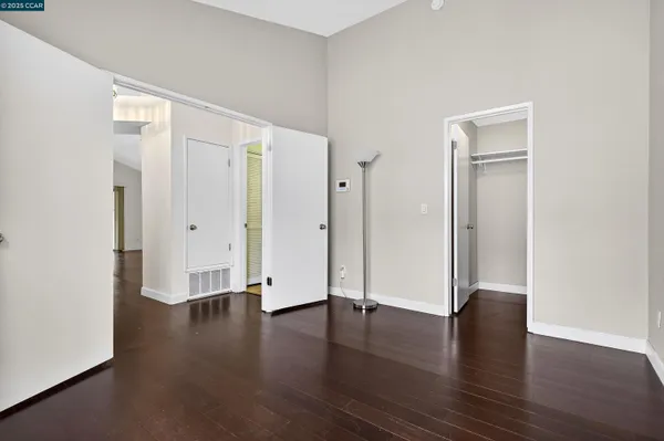 an empty room with wooden floor and closet