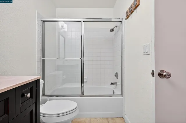 a bathroom with a shower a toilet and a sink