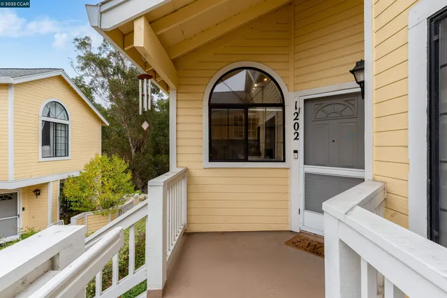 a view of a brick house with large windows