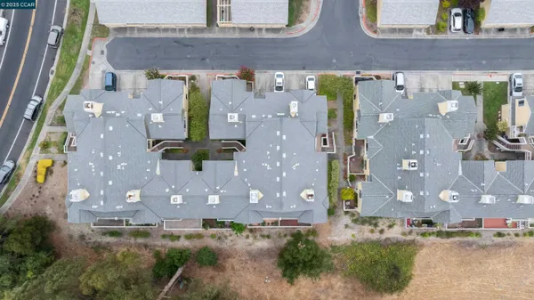 an aerial view of a house with yard
