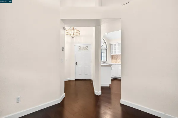 an empty room with wooden floor and mirror
