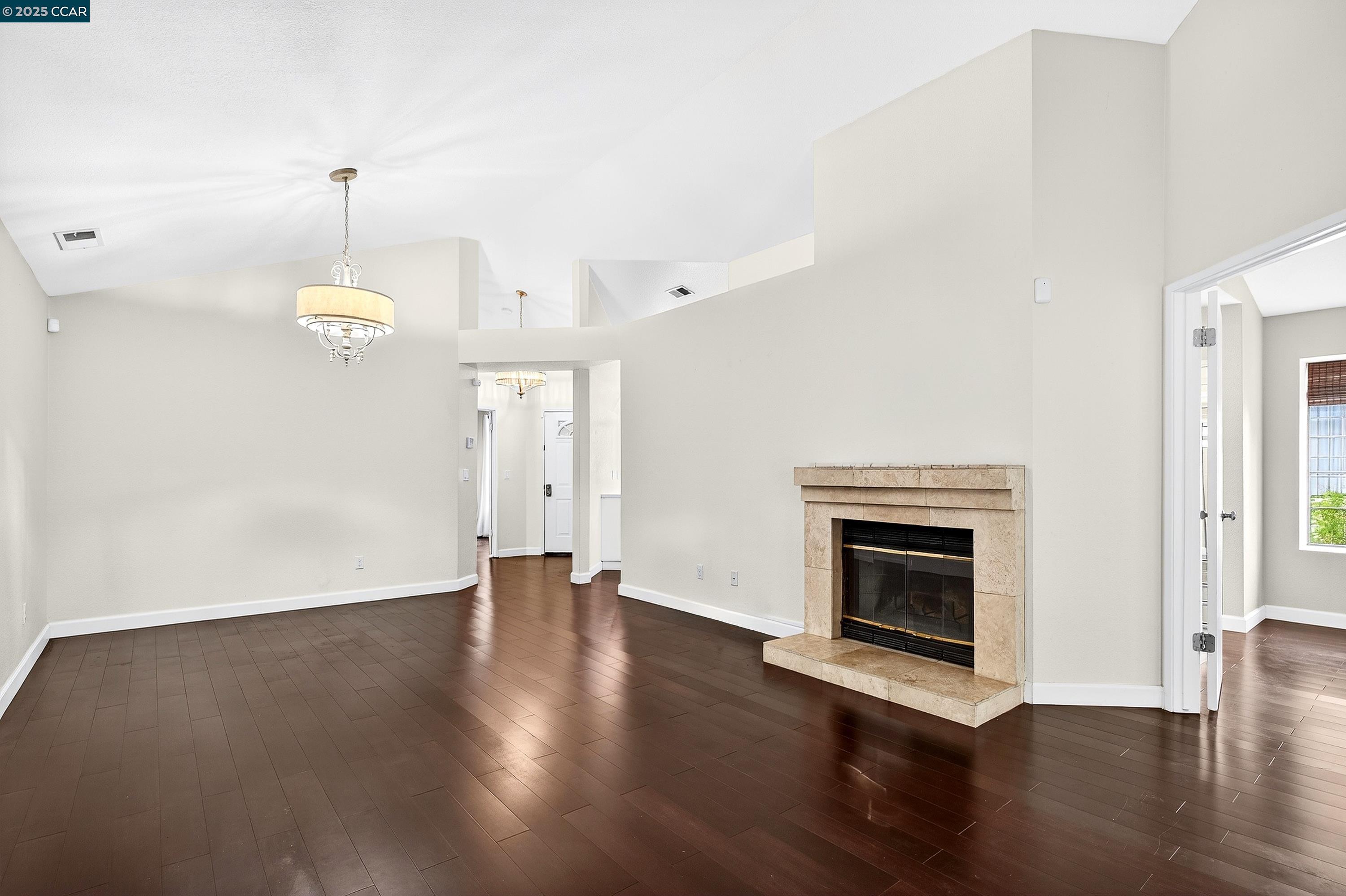 1202 Devonwood Hercules, CA 94547 - Photo 6 of 46 an empty room with wooden floor fireplace and windows