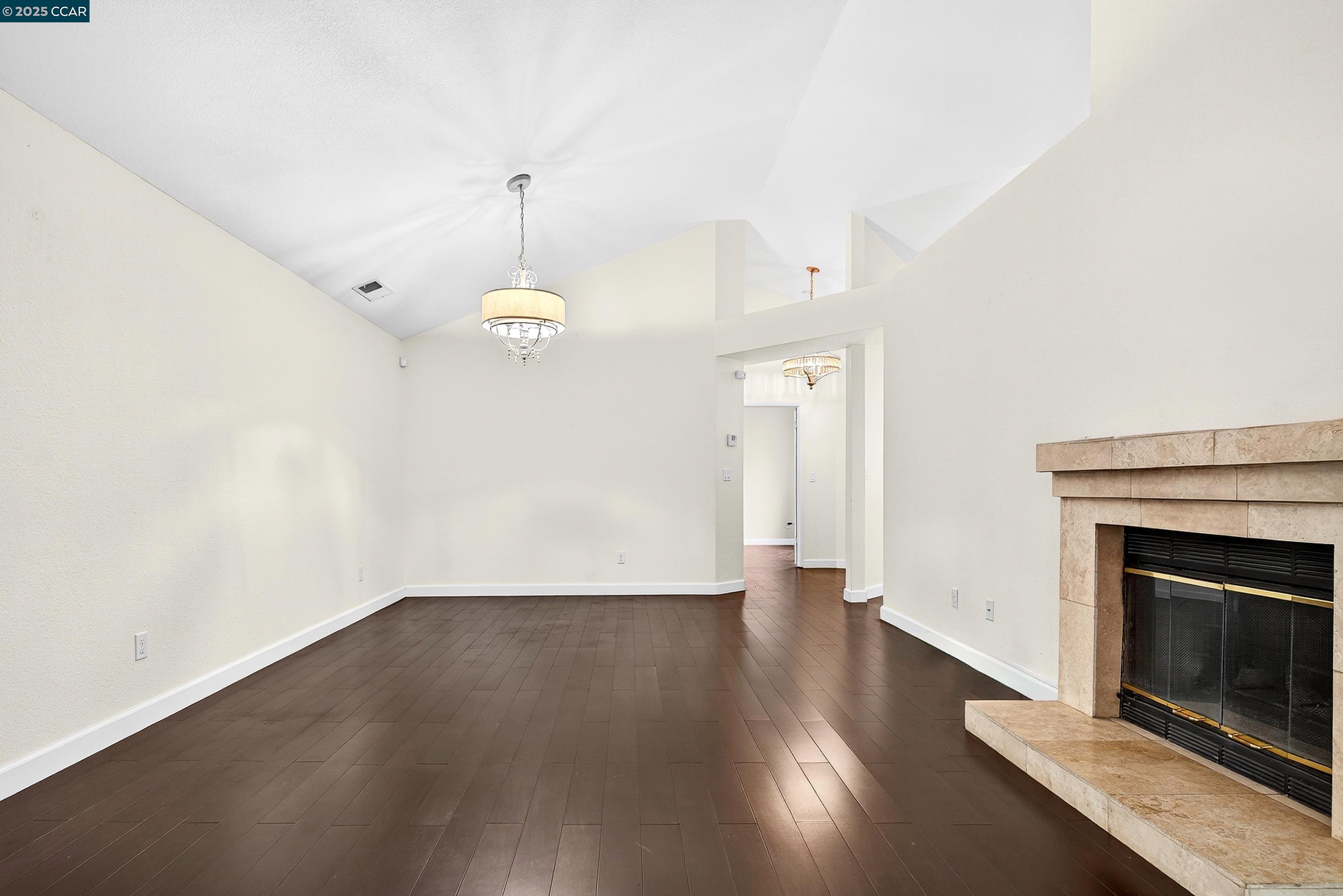 1202 Devonwood Hercules, CA 94547 - Photo 7 of 46 an empty room with wooden floor fireplace and windows