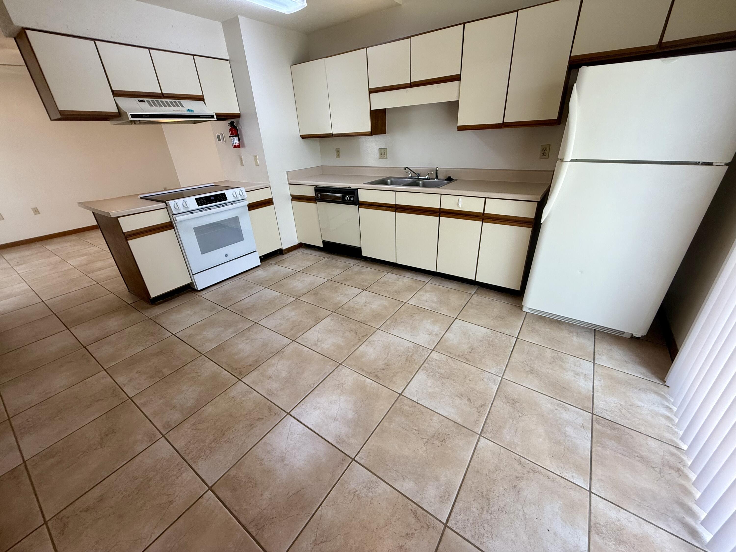 134 Alder Avenue Southeast Fort Walton Beach, FL 32548 - Photo 6 of 15 a kitchen with stainless steel appliances granite countertop a sink a stove a refrigerator a microwave and cabinets