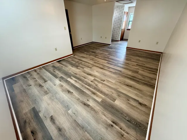 a view of room with wooden floor