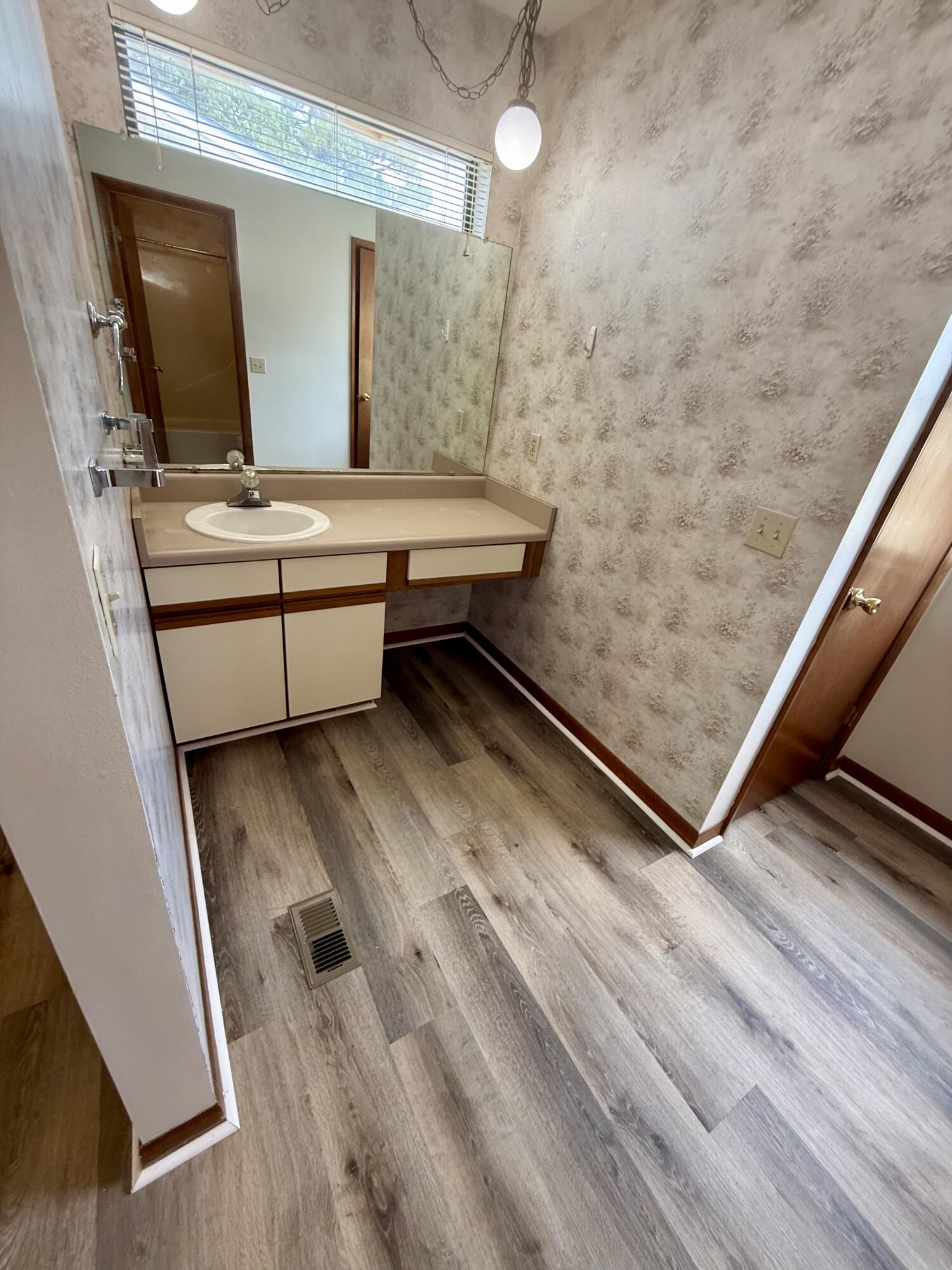 134 Alder Avenue Southeast Fort Walton Beach, FL 32548 - Photo 9 of 15 a bathroom with a sink a mirror and shower view