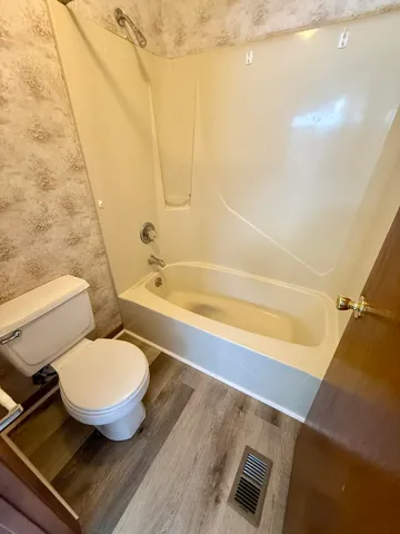 a bathroom with a toilet and a bathtub