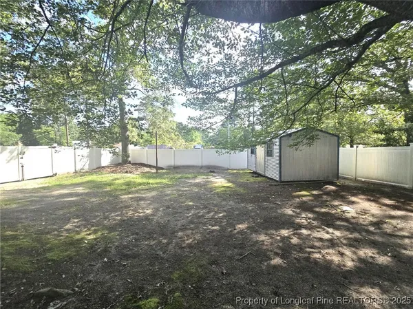 a view of a yard with a tree