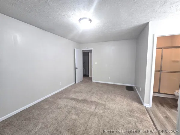 an empty room with a empty space and windows