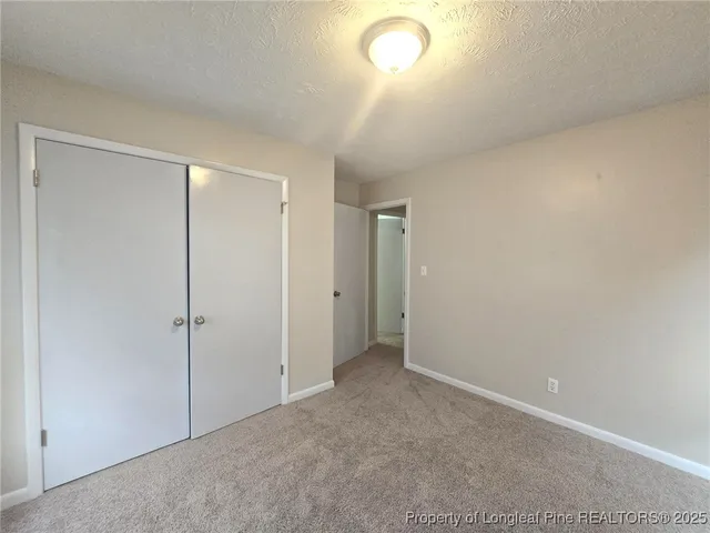 an empty room with closet area