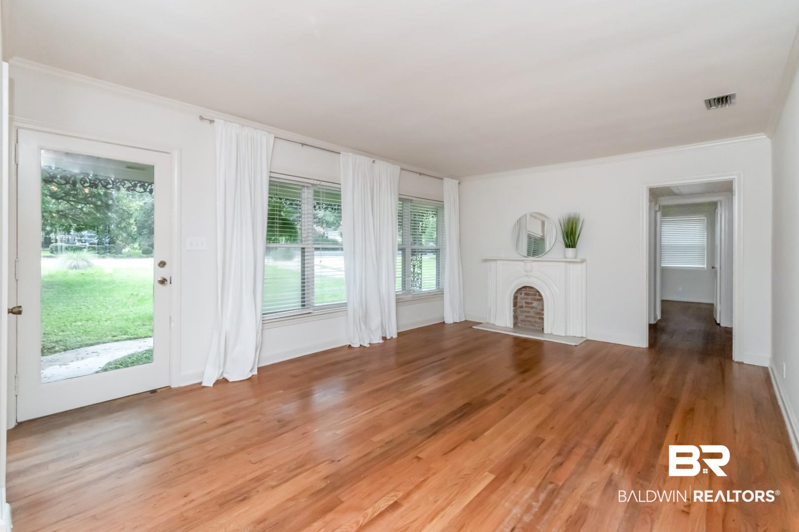 1906 Old Shell Road Mobile, AL 36607 - Photo 6 of 26 Unfurnished living room with light hardwood / wood-style flooring and ornamental molding