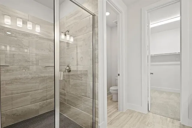 a bathroom with a granite countertop sink a mirror and a shower