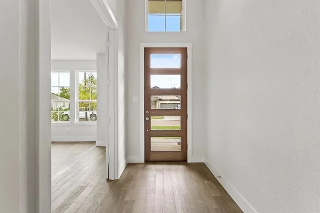 a kitchen with a refrigerator and a stove top oven