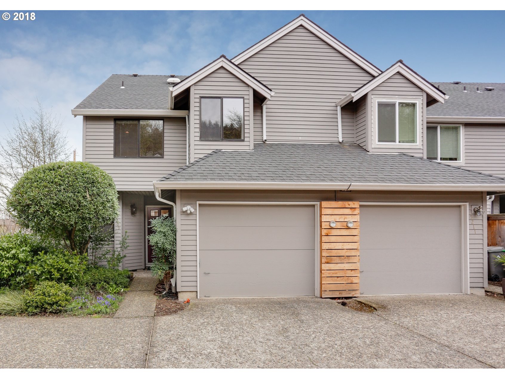 5209 Southwest View Point Terrace Portland, OR 97239 - Photo 1 of 32 a front view of a house with a yard and garage