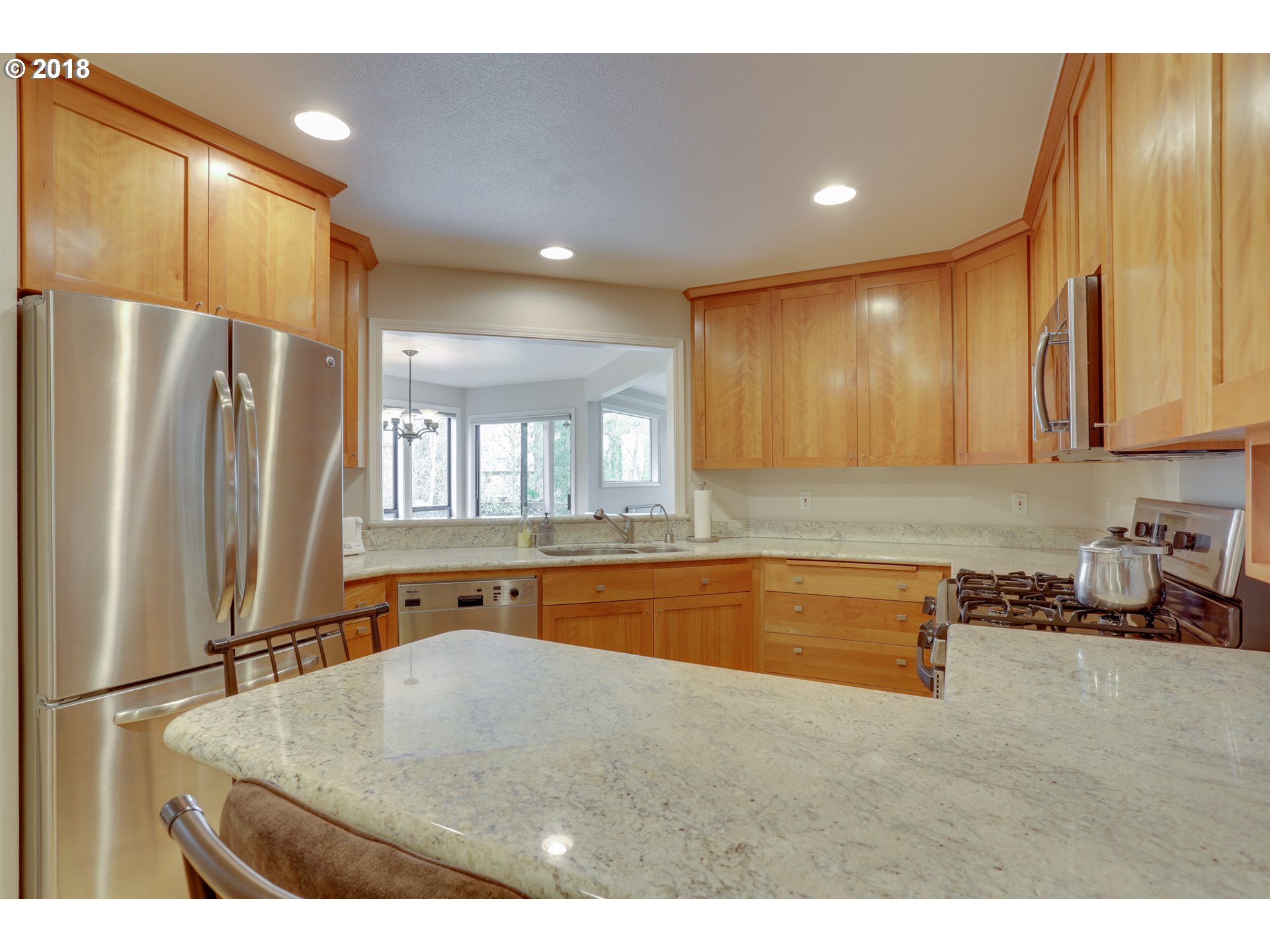 5209 Southwest View Point Terrace Portland, OR 97239 - Photo 11 of 32 a kitchen with stainless steel appliances granite countertop a refrigerator a sink and a stove