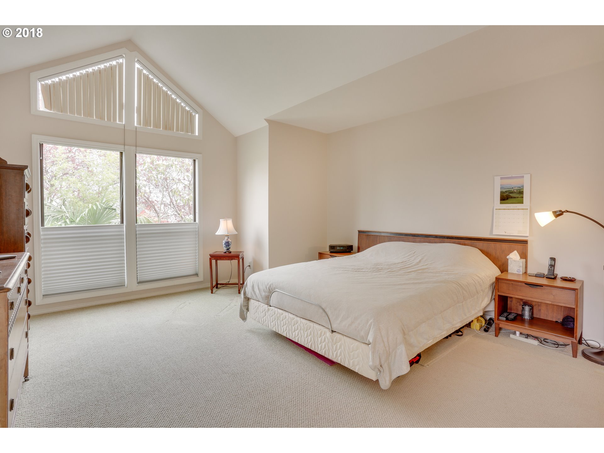 5209 Southwest View Point Terrace Portland, OR 97239 - Photo 13 of 32 a spacious bedroom with a bed and a window