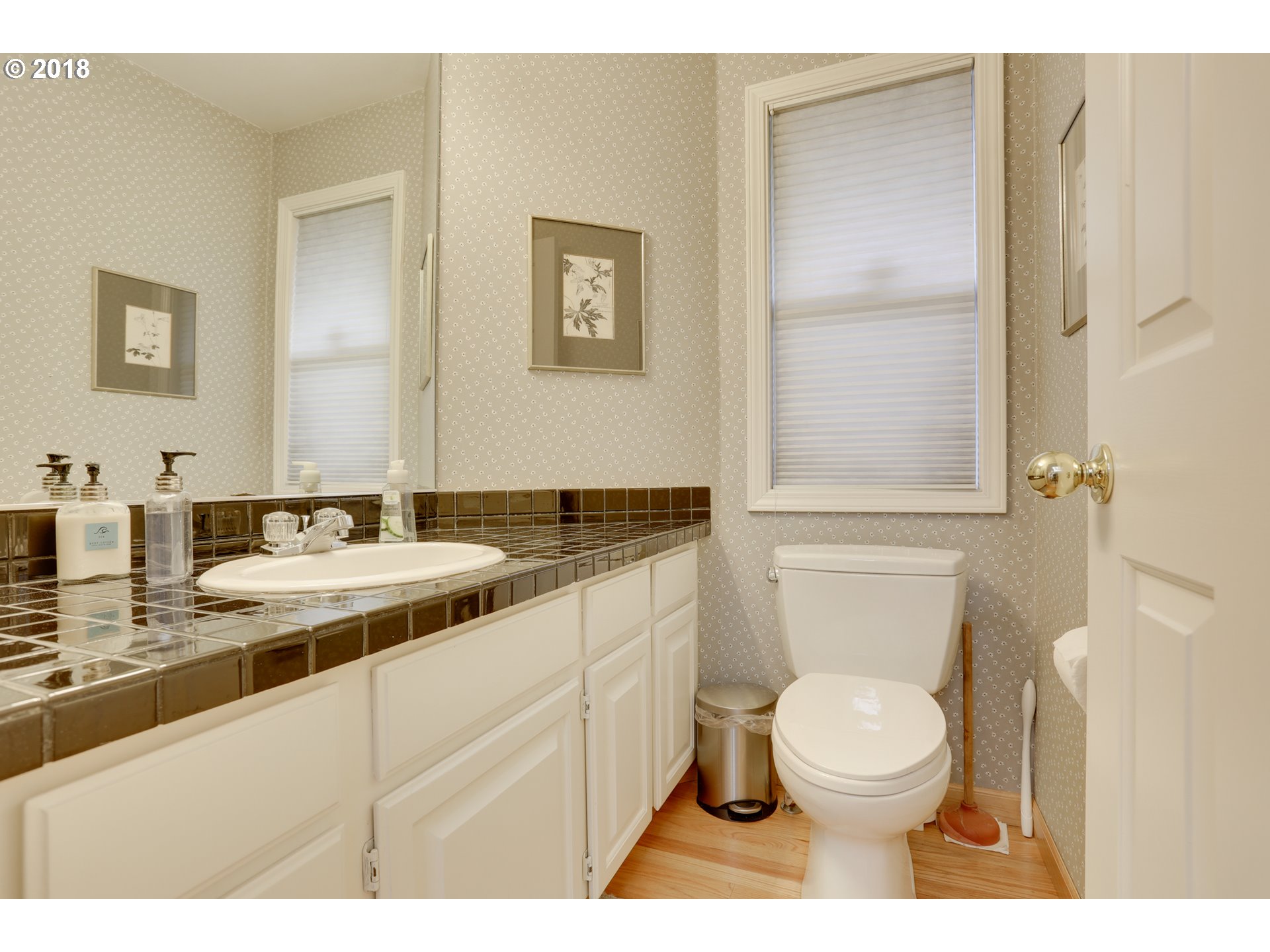 5209 Southwest View Point Terrace Portland, OR 97239 - Photo 17 of 32 a bathroom with a toilet a sink and mirror