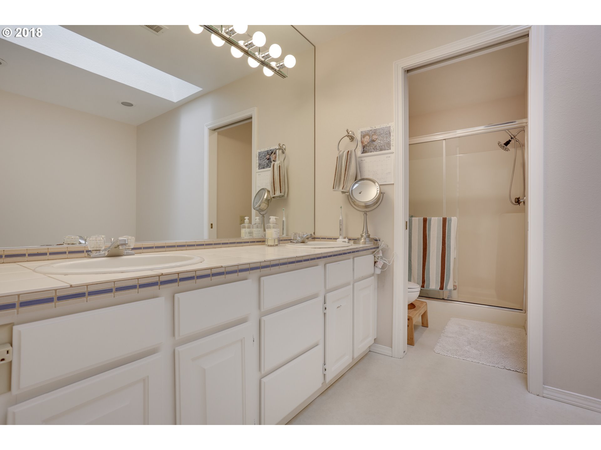 5209 Southwest View Point Terrace Portland, OR 97239 - Photo 18 of 32 a bathroom with a double vanity sink and mirror