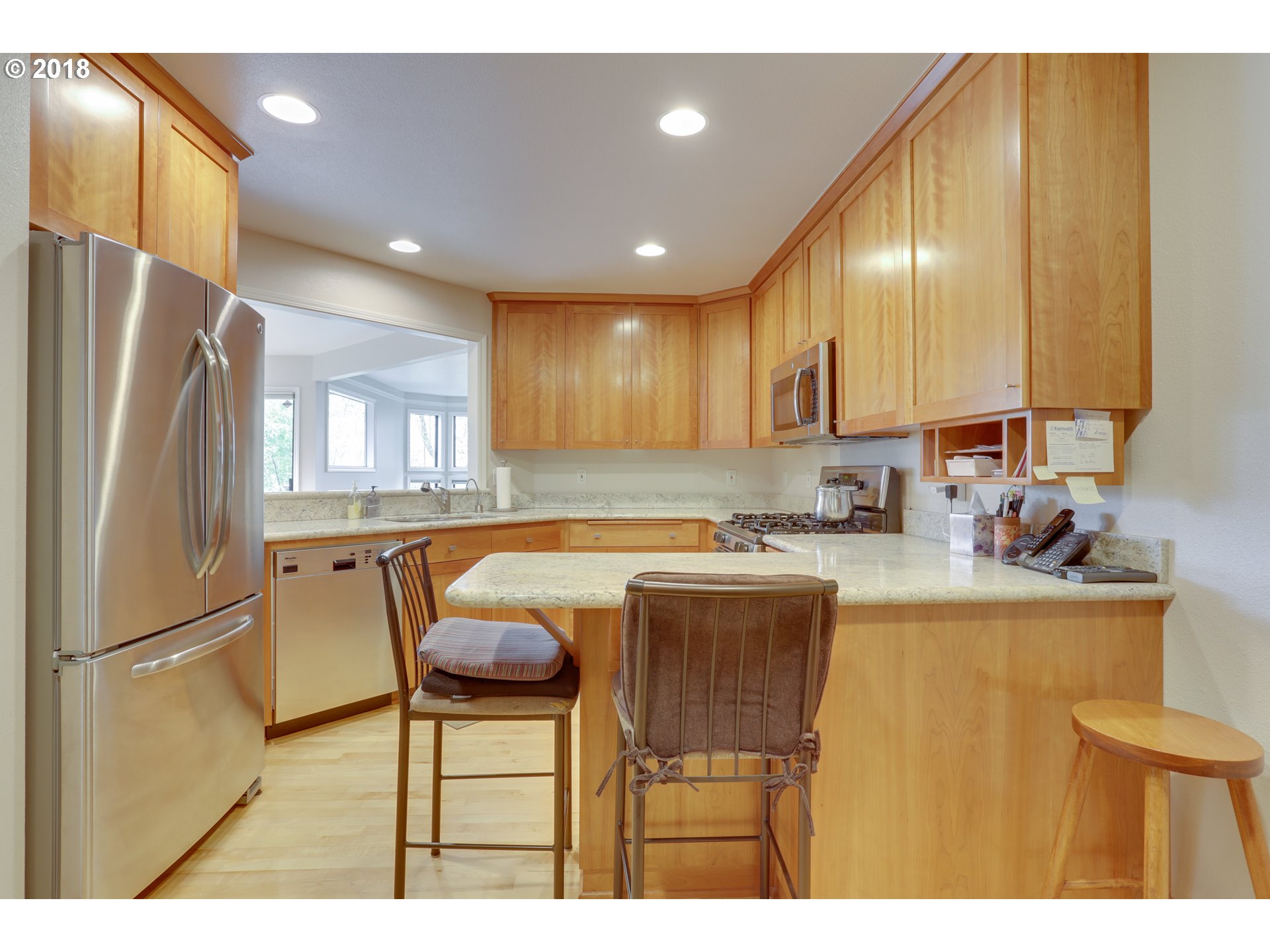 5209 Southwest View Point Terrace Portland, OR 97239 - Photo 10 of 32 a kitchen with granite countertop a refrigerator and a sink