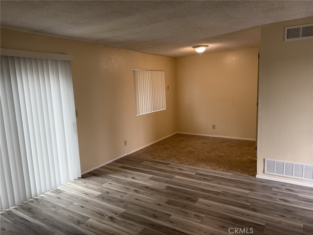 9090 Colony Place, Unit B Riverside, CA 92503 - Photo 7 of 19 wooden floor in an empty room with a window
