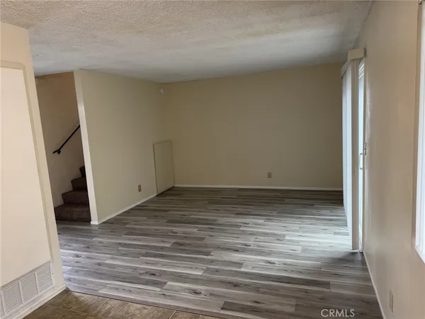 a view of a room with wooden floor
