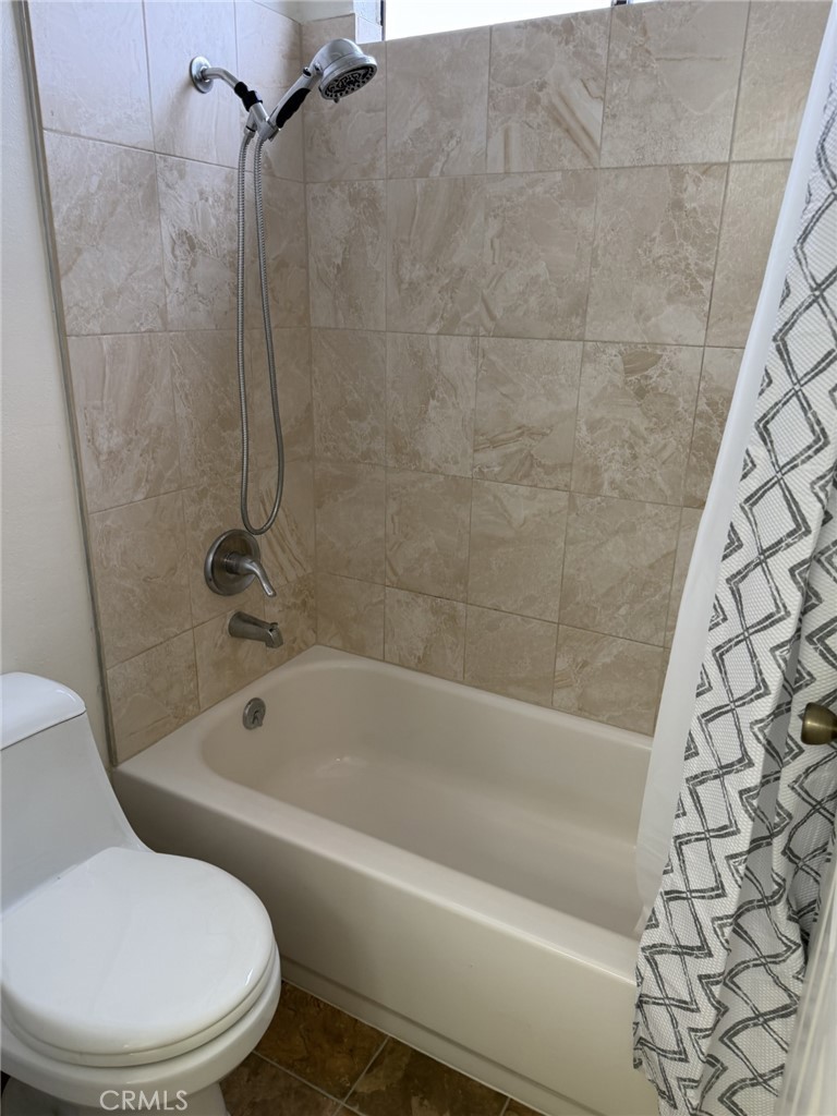 9090 Colony Place, Unit B Riverside, CA 92503 - Photo 10 of 19 a white toilet sitting next to a bath tub and shower