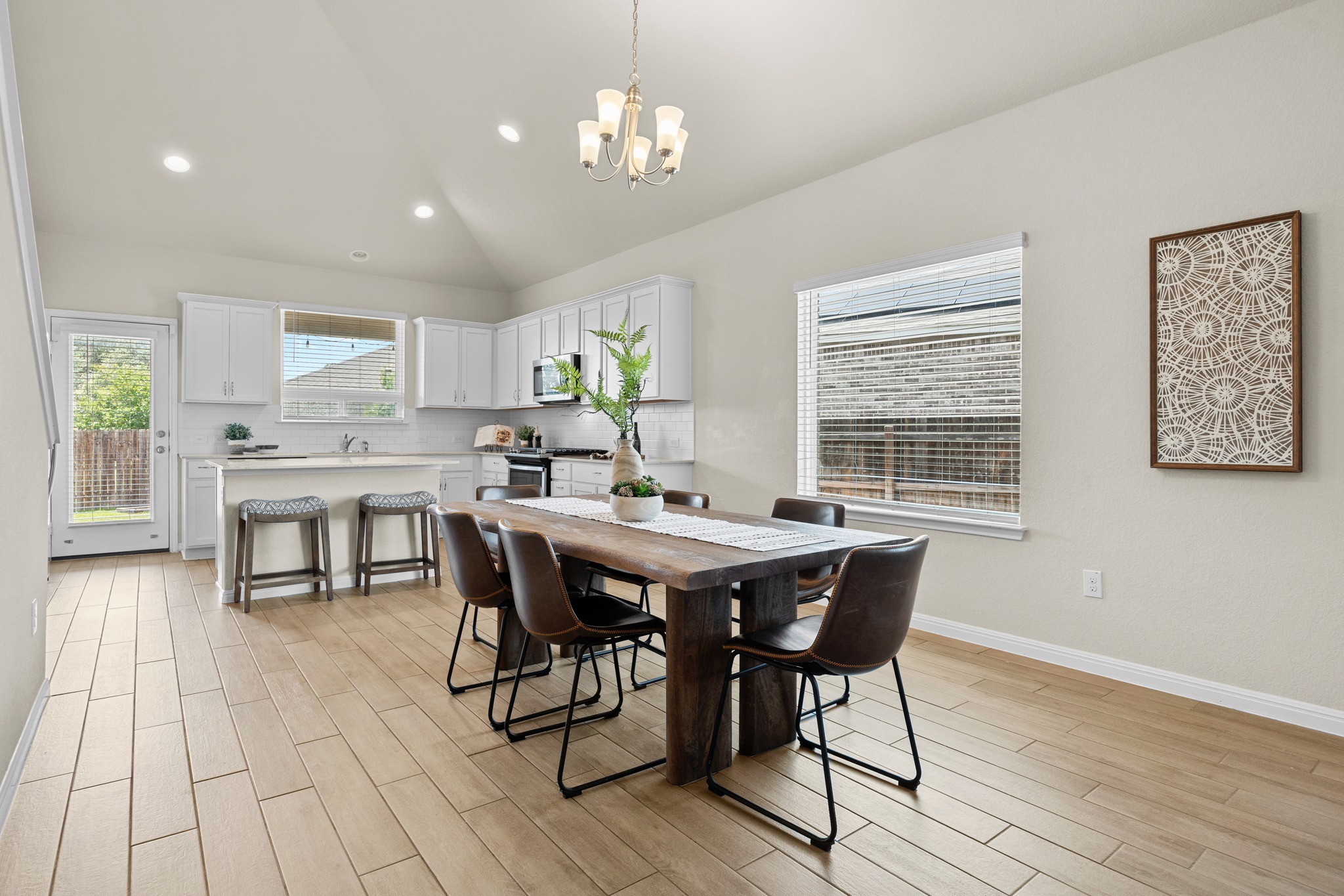 2413 Starhill Ranch Street Georgetown, TX 78628 - Photo 12 of 40 a view of a dining room with furniture window and wooden floor