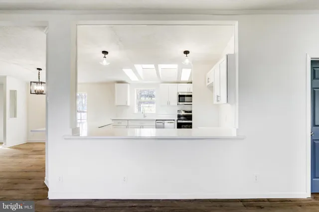 a view of a living room with wooden floor