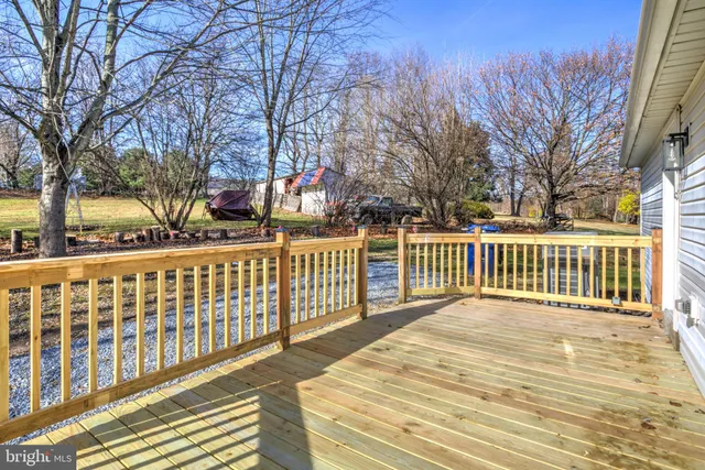 a view of backyard of house with green space