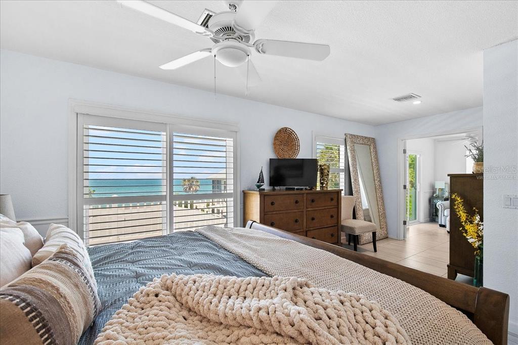 8400 Manasota Key Road Englewood, FL 34223 - Photo 15 of 31 a bedroom with a bed and a flat screen tv