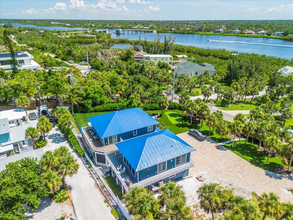 8400 Manasota Key Road Englewood, FL 34223 - Photo 24 of 31 an aerial view of a house with a yard and lake view