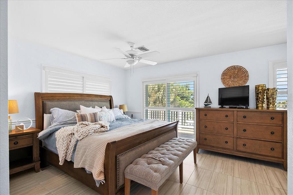 8400 Manasota Key Road Englewood, FL 34223 - Photo 31 of 31 a bedroom with a bed and a flat screen tv