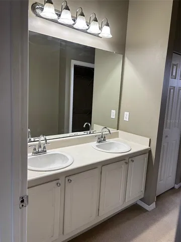 a bathroom with a sink vanity and mirror