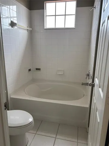 a white bath tub sitting next to a white toilet
