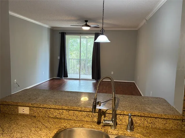 a kitchen with kitchen island a large counter top space and a chandelier
