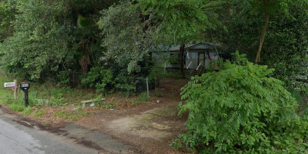 6942 Southwest 86th Street Ocala, FL 34476 - Photo 1 of 8 a view of backyard with green space