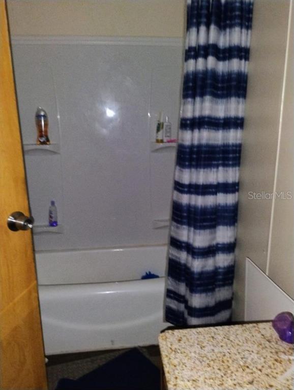 6942 Southwest 86th Street Ocala, FL 34476 - Photo 4 of 8 a bathroom with a bathtub and a shower