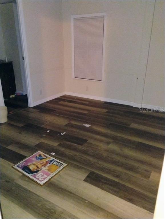 6942 Southwest 86th Street Ocala, FL 34476 - Photo 5 of 8 a view of room with window and wooden floor