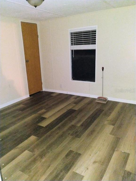 6942 Southwest 86th Street Ocala, FL 34476 - Photo 8 of 8 a view of empty room with wooden floor