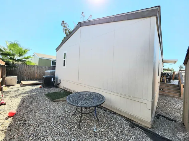 a view of a backyard with furniture and a rug