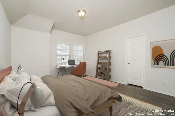 a bedroom with a bed and with furniture