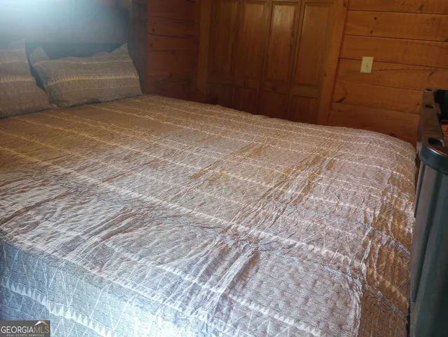 a bed sitting in a bedroom next to a window