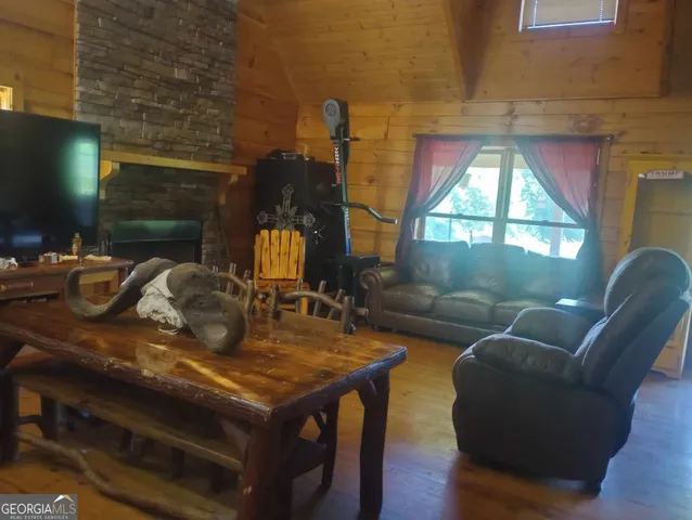 a room with pool table and chairs