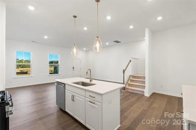 a view of a kitchen counter space and wooden floor