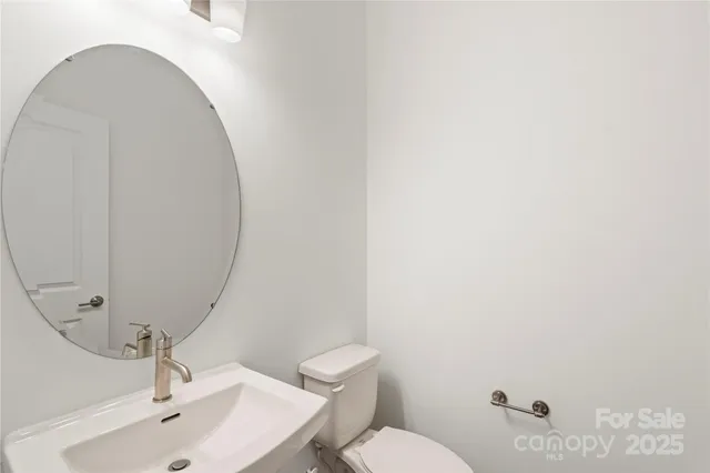 a bathroom with a sink mirror and toilet