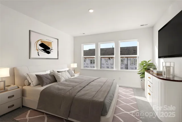 a bedroom with a balcony a bed and a flat screen tv