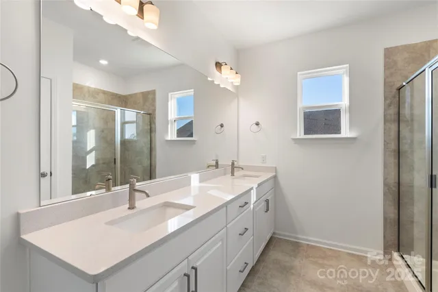 a bathroom with a sink double vanity and a mirror